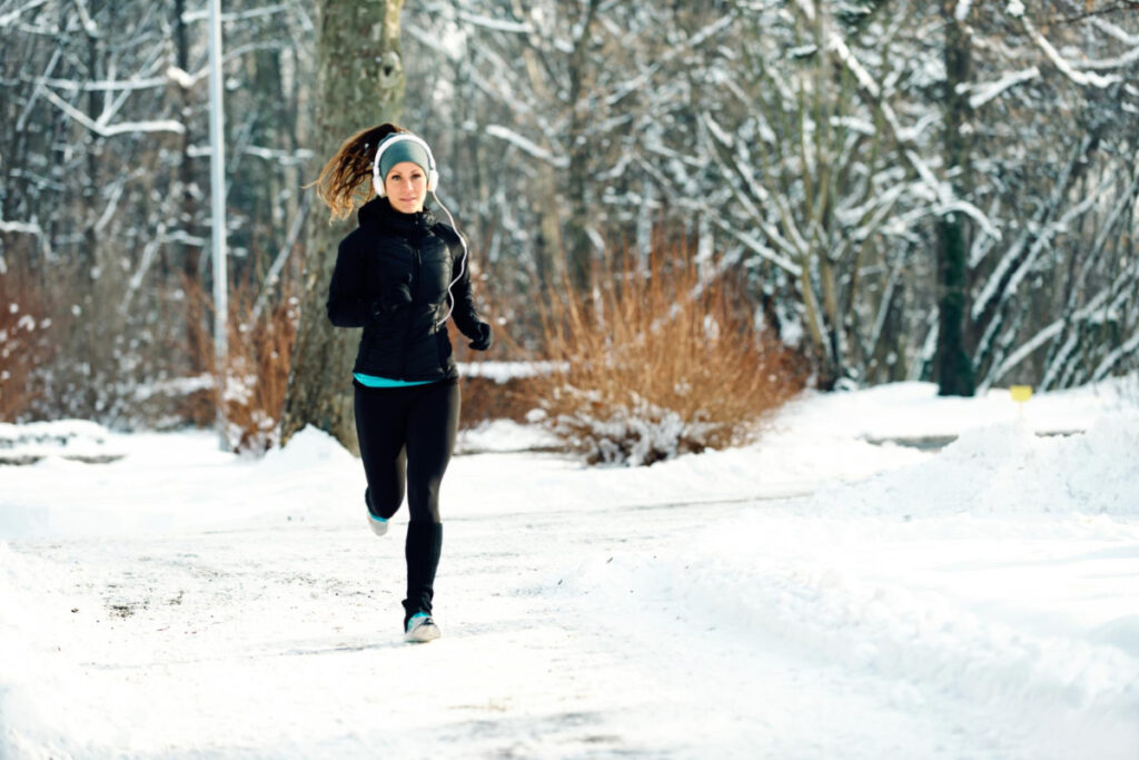 Kobieta biega w zimie w parku